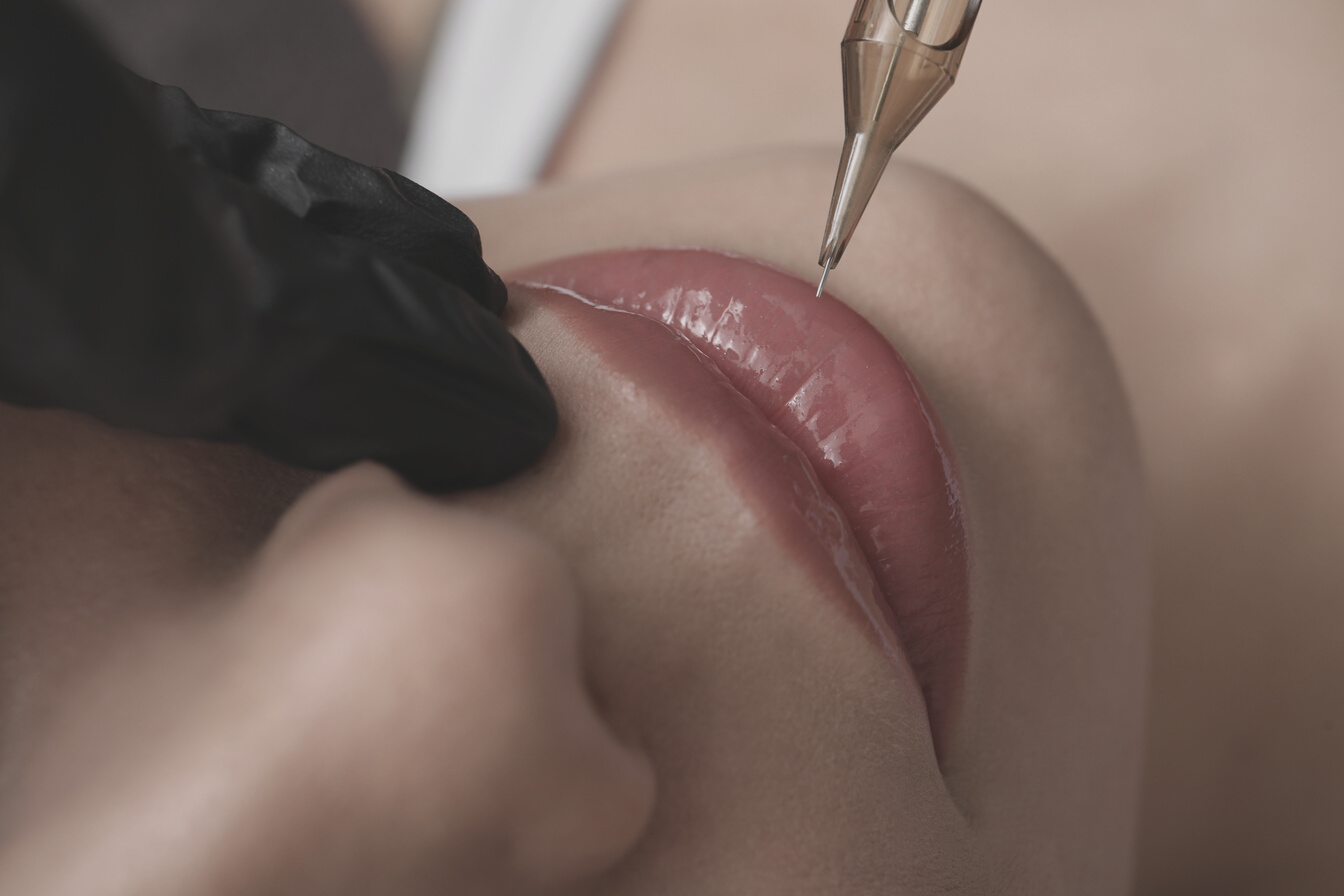 Young Woman Undergoing Procedure of Permanent Lip Makeup in Tatt